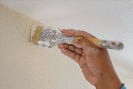 Paint brush painting the wall