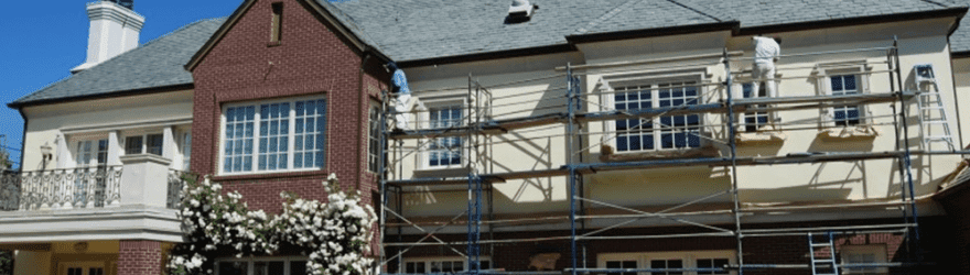 Painter Painting Exterior of Home 